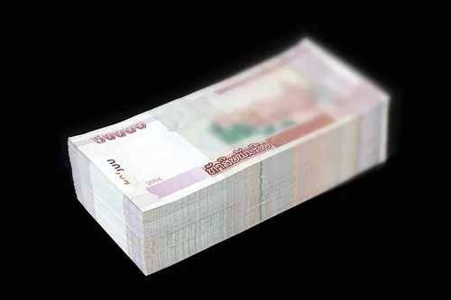 Stack of 360 new banknotes of 50'000 kips, on a black background. 18 millions LAK (Laotian kip, currency from Laos) in total.